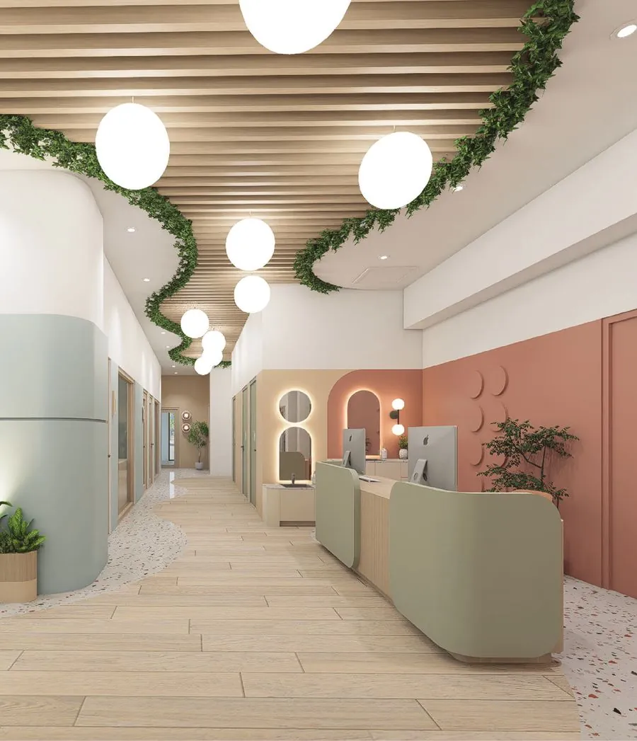 A bright Kindred classroom with arched windows, wooden shelving and soft green seating