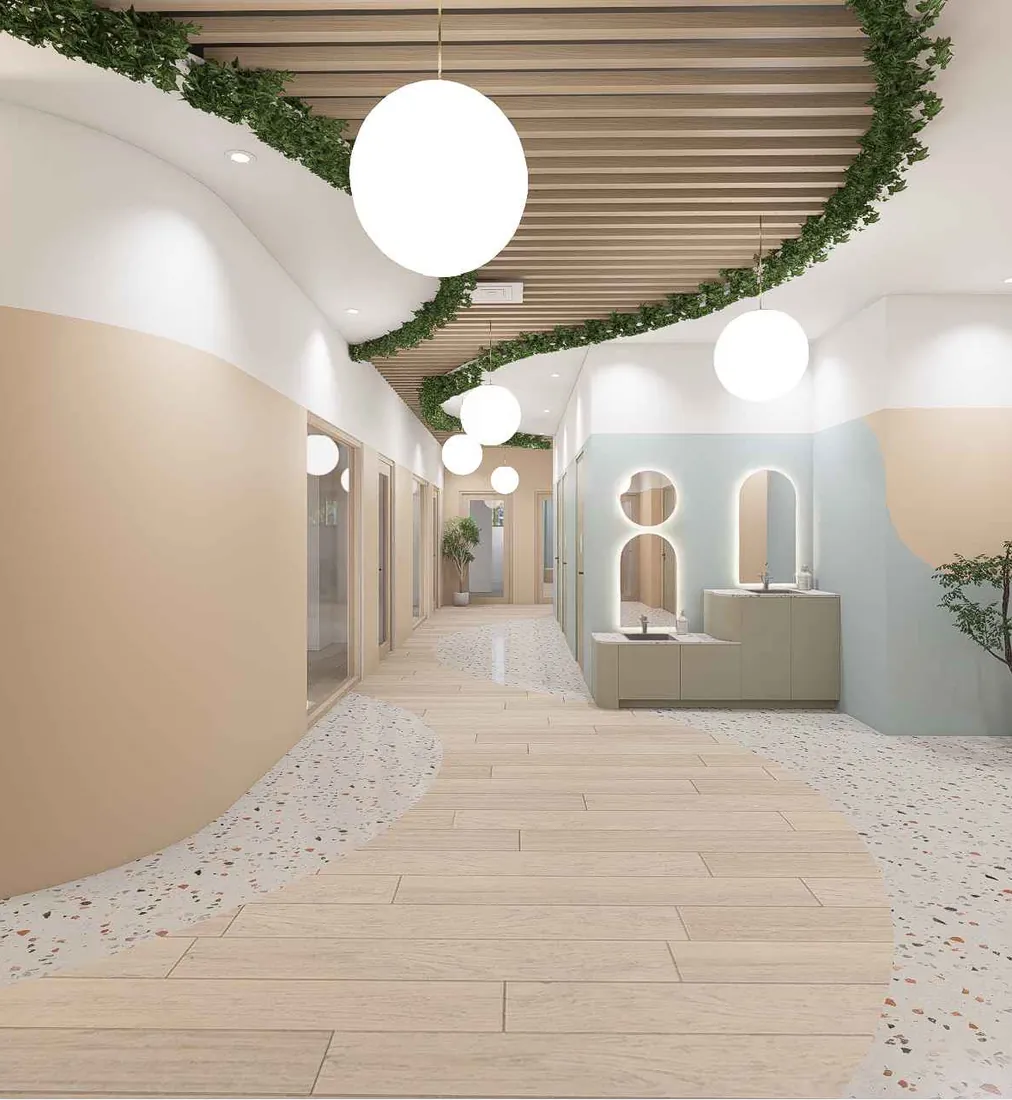 The cellar hallway at Kindred Greenpoint, with curved walls, a wood baffle ceiling and child-height sinks
